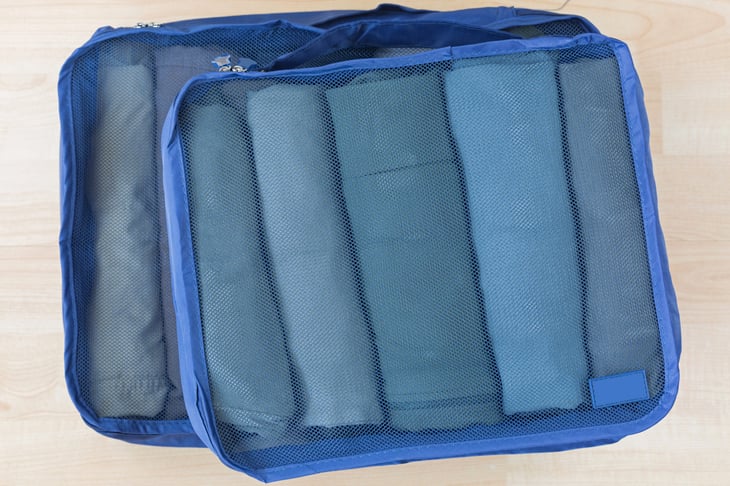 Mesh packing cubes for organizing luggage or bags while traveling.