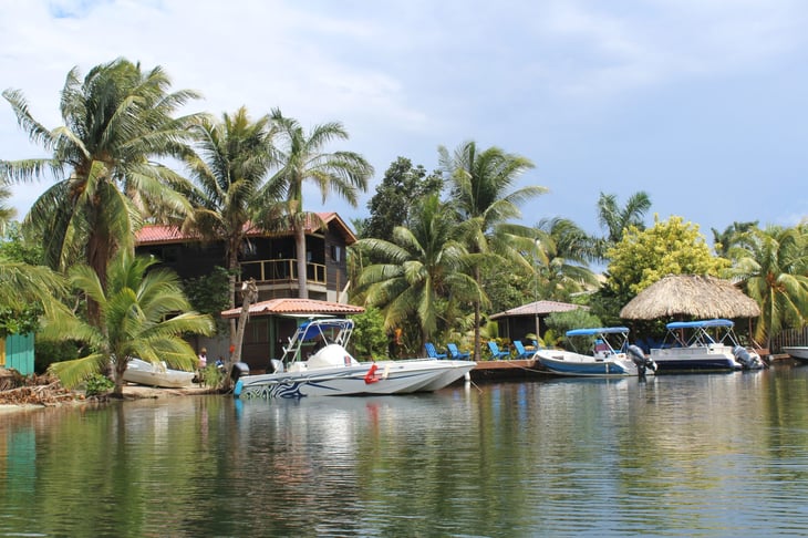 Placencia, Belize. sail boats moored next to homes