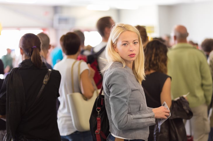 Frustrated traveler standing in line at the airport