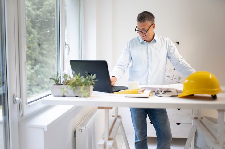 Construction manager working at a standing desk.