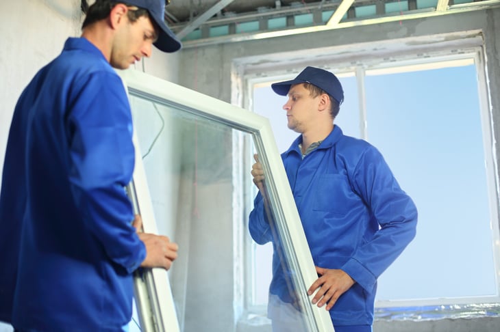 Workers installing a window