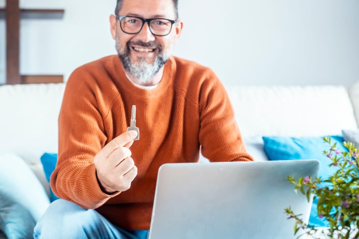 Man holding the key to his new home
