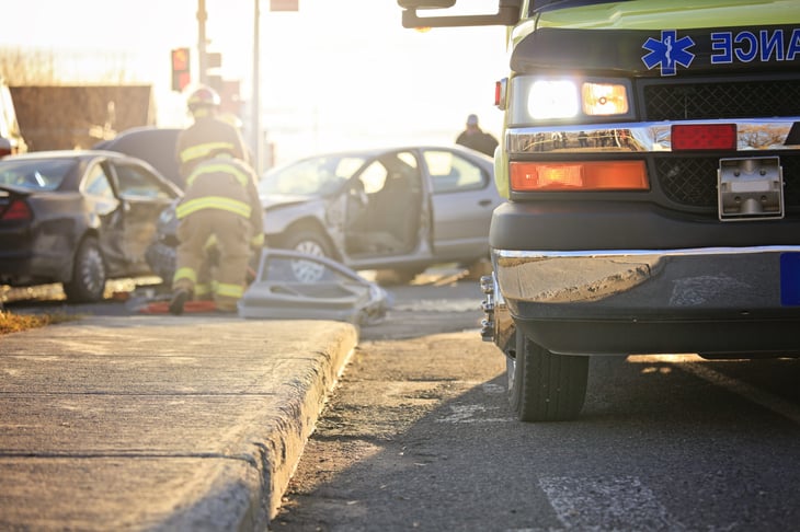 Paramedics providing care after a car crash.