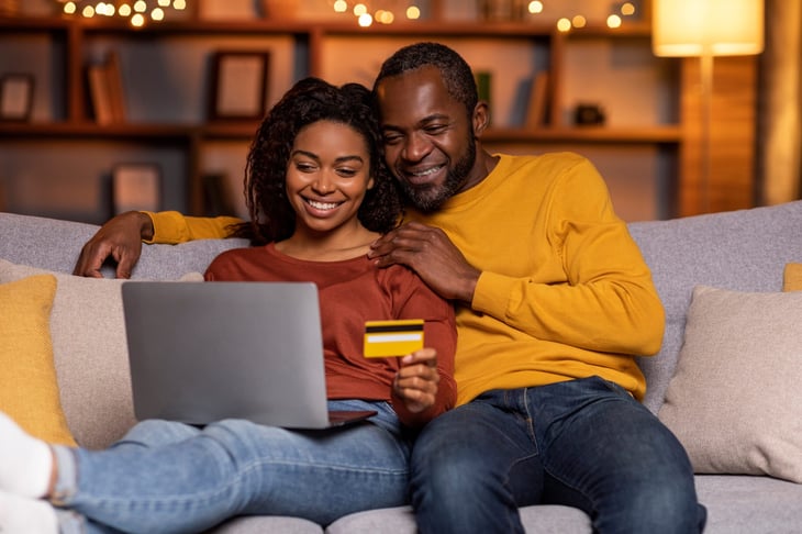 Couple shopping online with a credit card