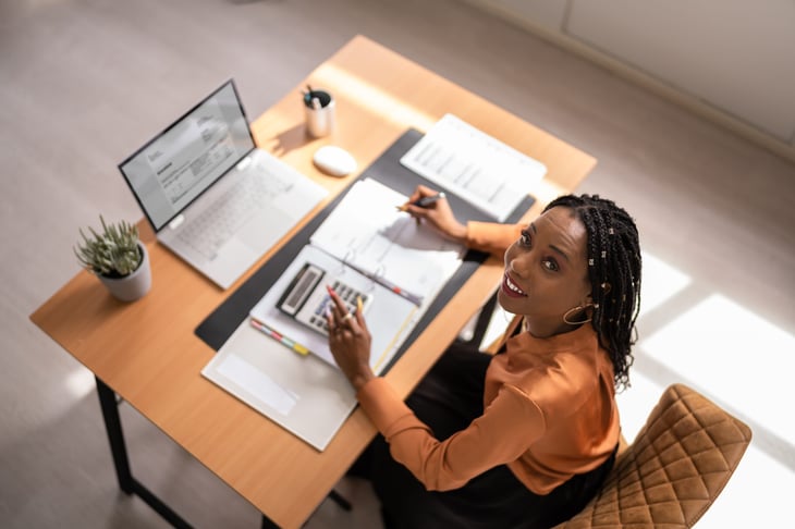 Woman at her desk calculating taxes