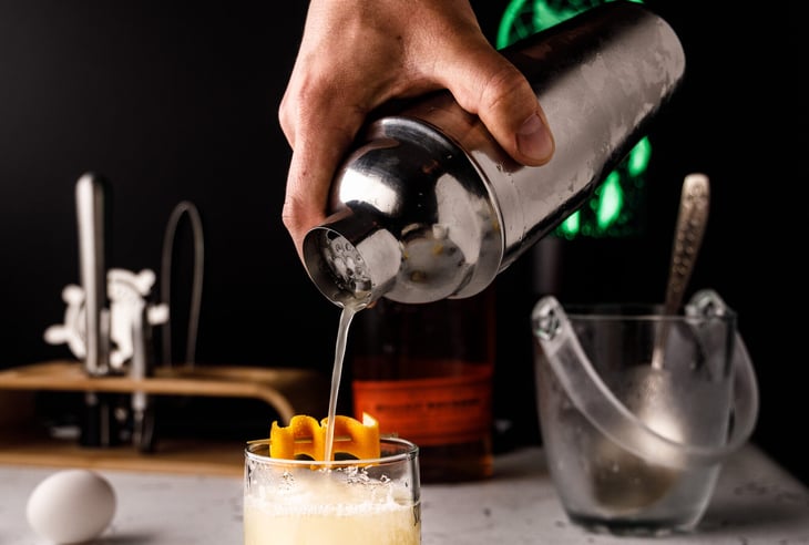 Bartender making cocktail.
