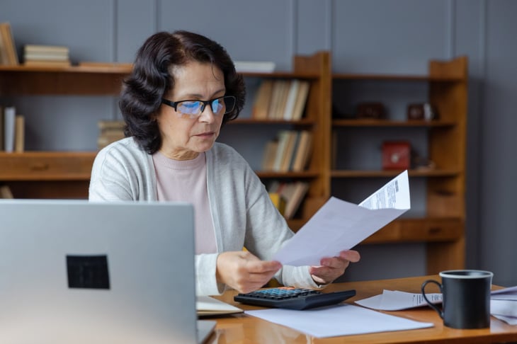 Senior woman applying for benefits on a laptop