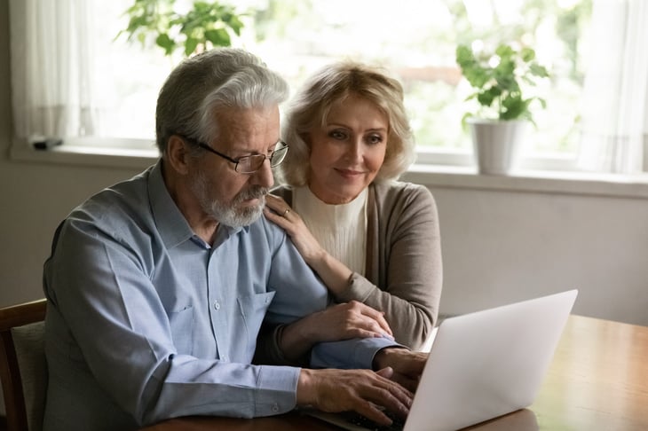 Older couple looking content at computer.