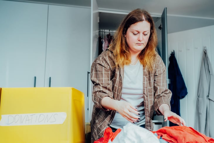 woman packing up clothes for donation
