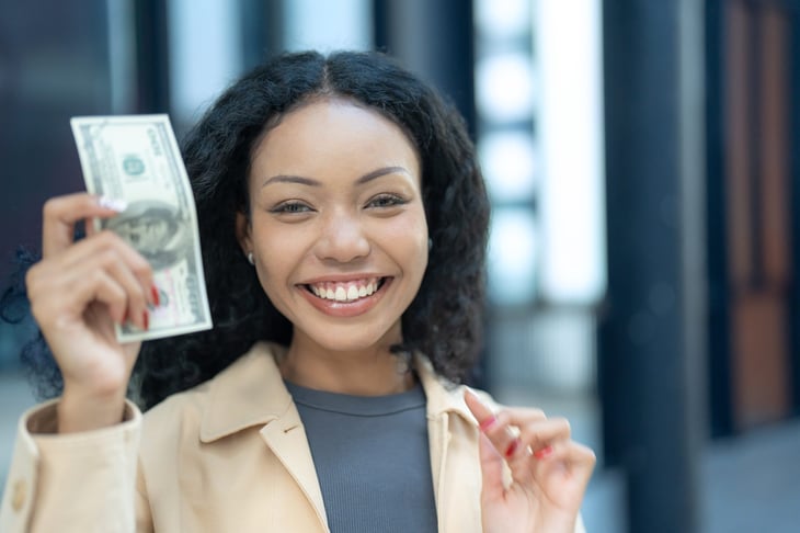 Happy woman holding money