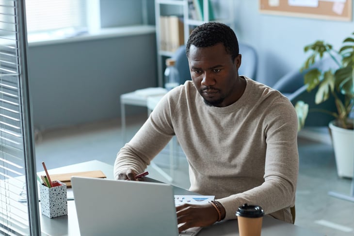 man working remotely on a laptop