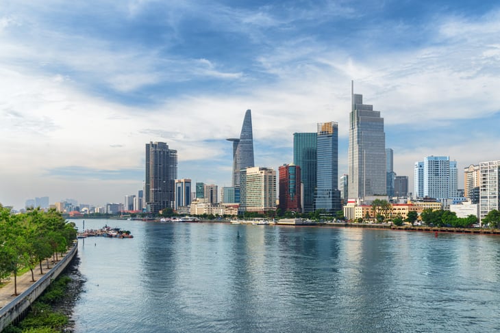 Ho Chi Minh City, Vietnam skyline. View of skyscrapers and other high-rise buildings reflected in water of the Saigon River at downtown of Ho Chi Minh City, Vietnam.