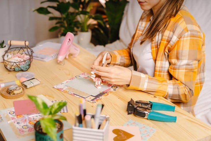 Woman creating scrapbook