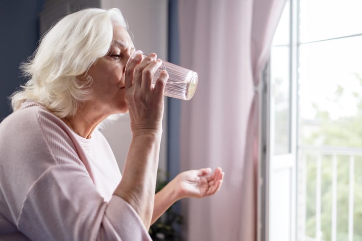 Senior woman taking a pill
