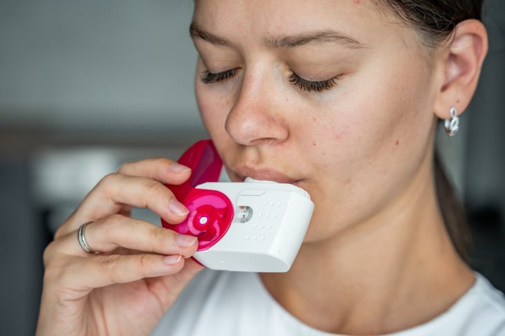 Woman using an inhaler