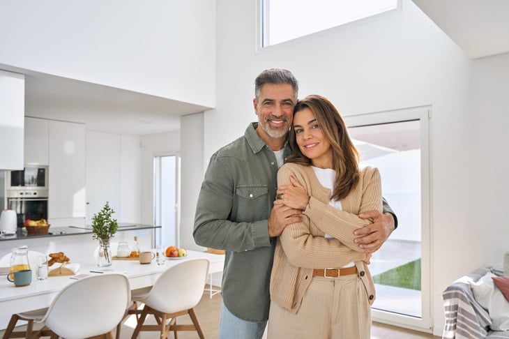 happy couple standing in dining room