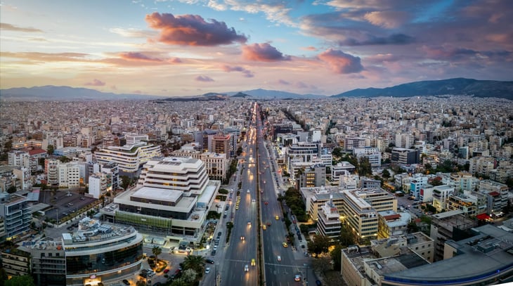 Skyline of Athens, Greece, during sunset with Syggrou Avenue leading from the south suburbs in to the city center
