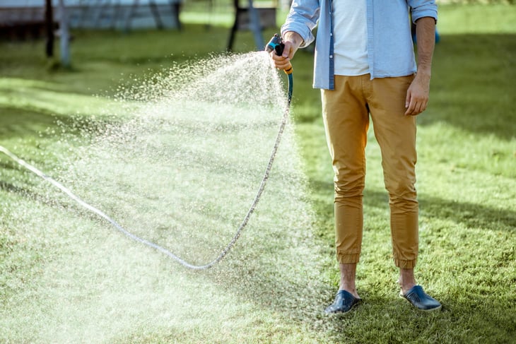 Man watering grass