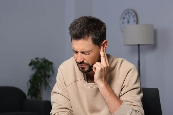 Unhappy man with tinnitus