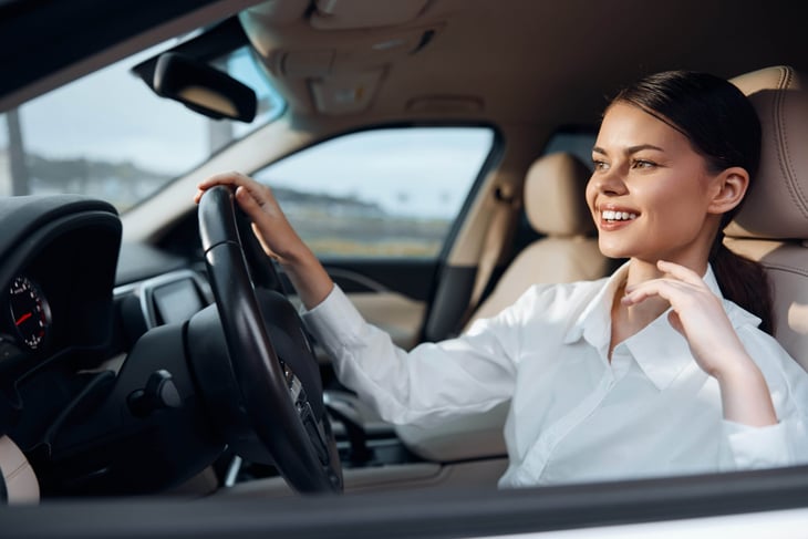 Smiling woman driving an SUV