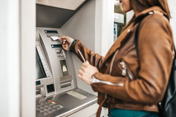 Woman pulling money out of an ATM