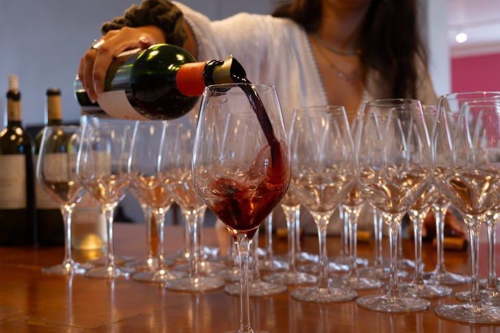 Pouring a glass of Bordeaux wine
