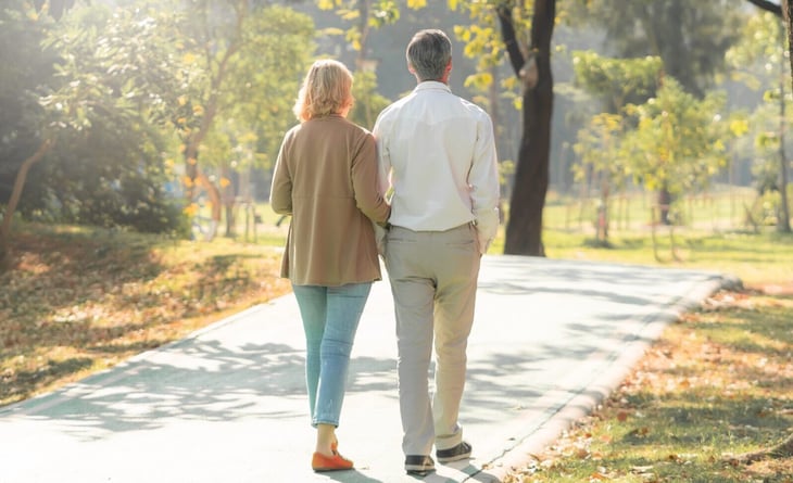 An older couple taking a walk in the park
