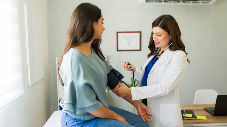 Doctor doing blood pressure reading