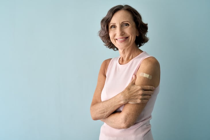 Vaccinated woman with a band aid