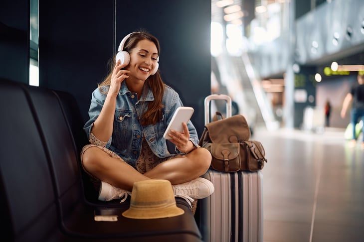 Happy female traveler in an airport