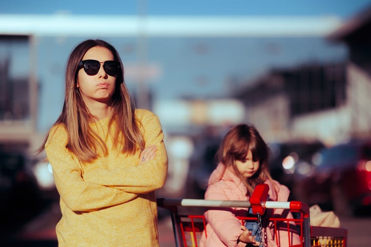 Frustrated mom shopping with her kid