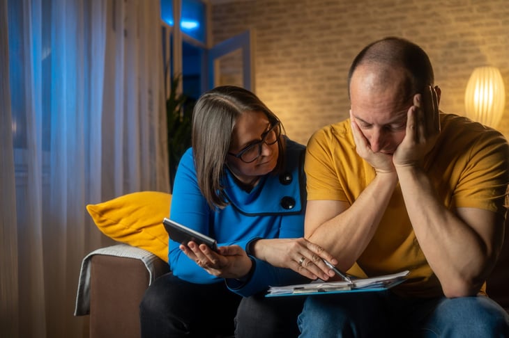 Worried couple balancing their budget