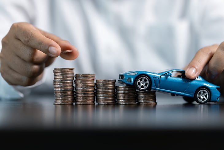 Toy car driving over rising costs