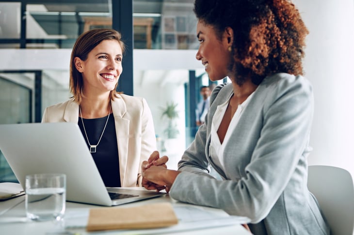 Two women talk at work
