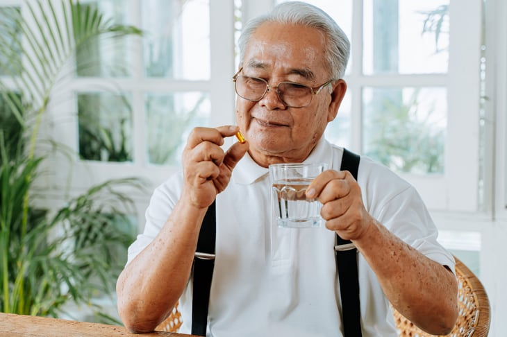 Senior man taking a pill