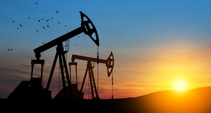 Oil drilling derricks at desert oilfield. Crude oil production from the ground. Petroleum production.