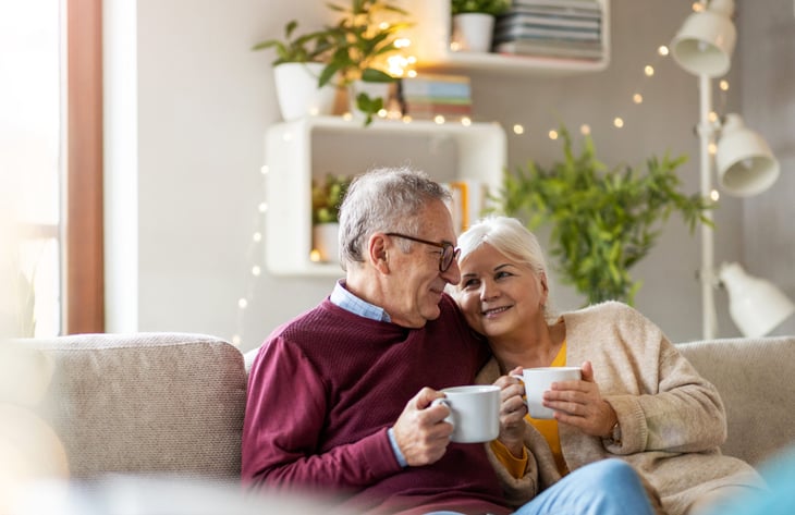 Happy senior couple drinking coffee or tea