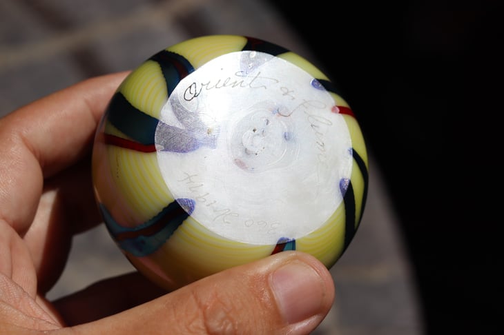 Signature on the underside of an Orient and Flume art glass paperweight