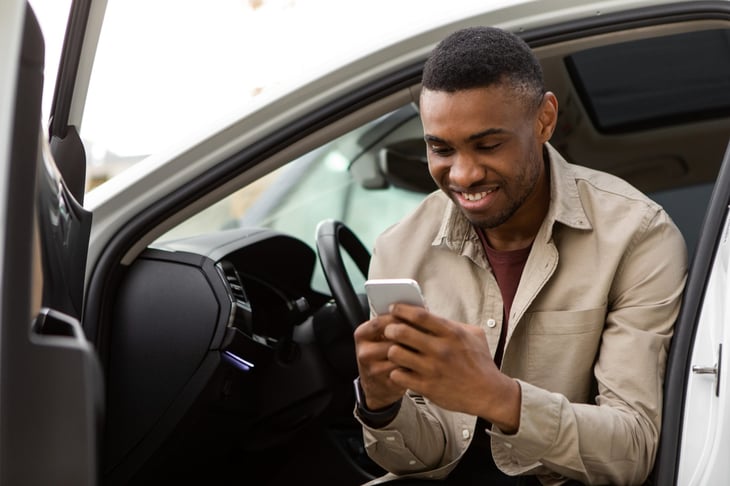 Happy male driver switching insurance companies