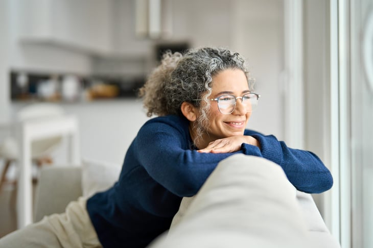 Happy middle-aged woman on her couch