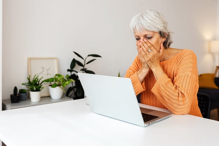 Senior woman in shock looking at her computer