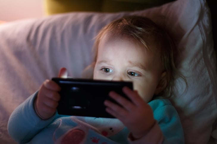 Child using a phone to stream video