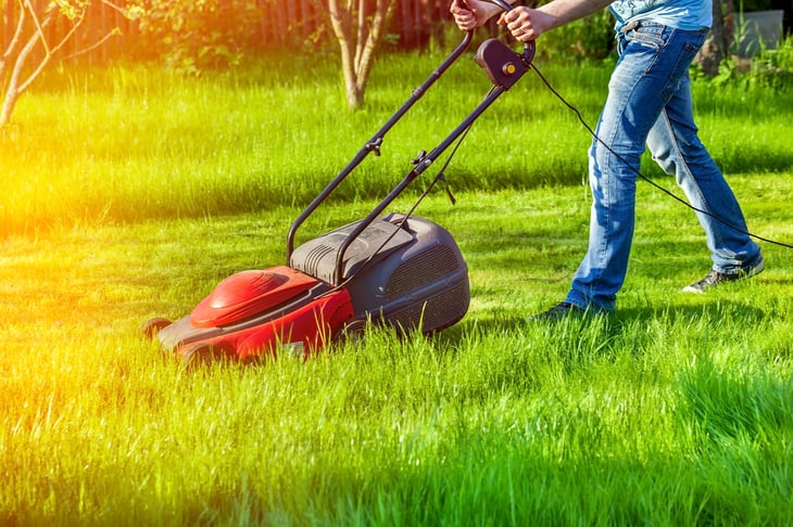 A man mows a lawn