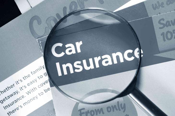 the words car insurance in a magnifying glass