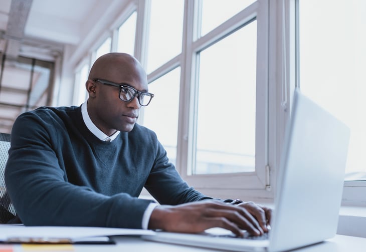 A man types on a computer