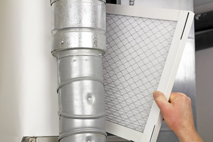 replacing disposable air filter in residential air furnace.