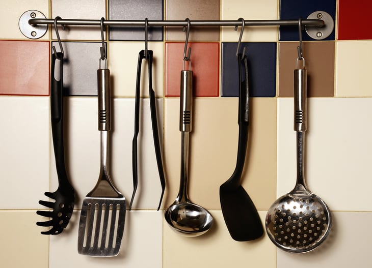 S hooks hold cooking utensils