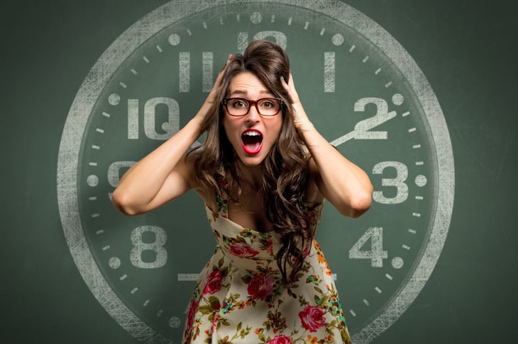Panicked woman in front of a large clock