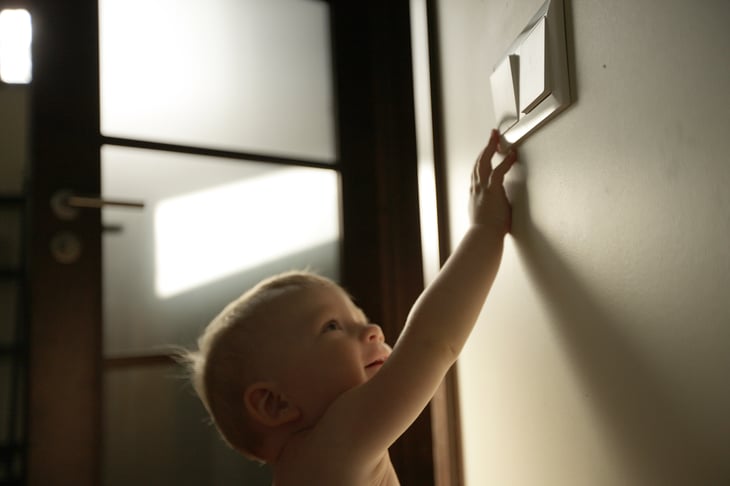 A baby turns off the lights