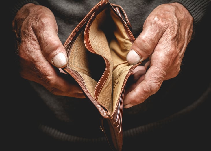 A senior man opens an empty wallet